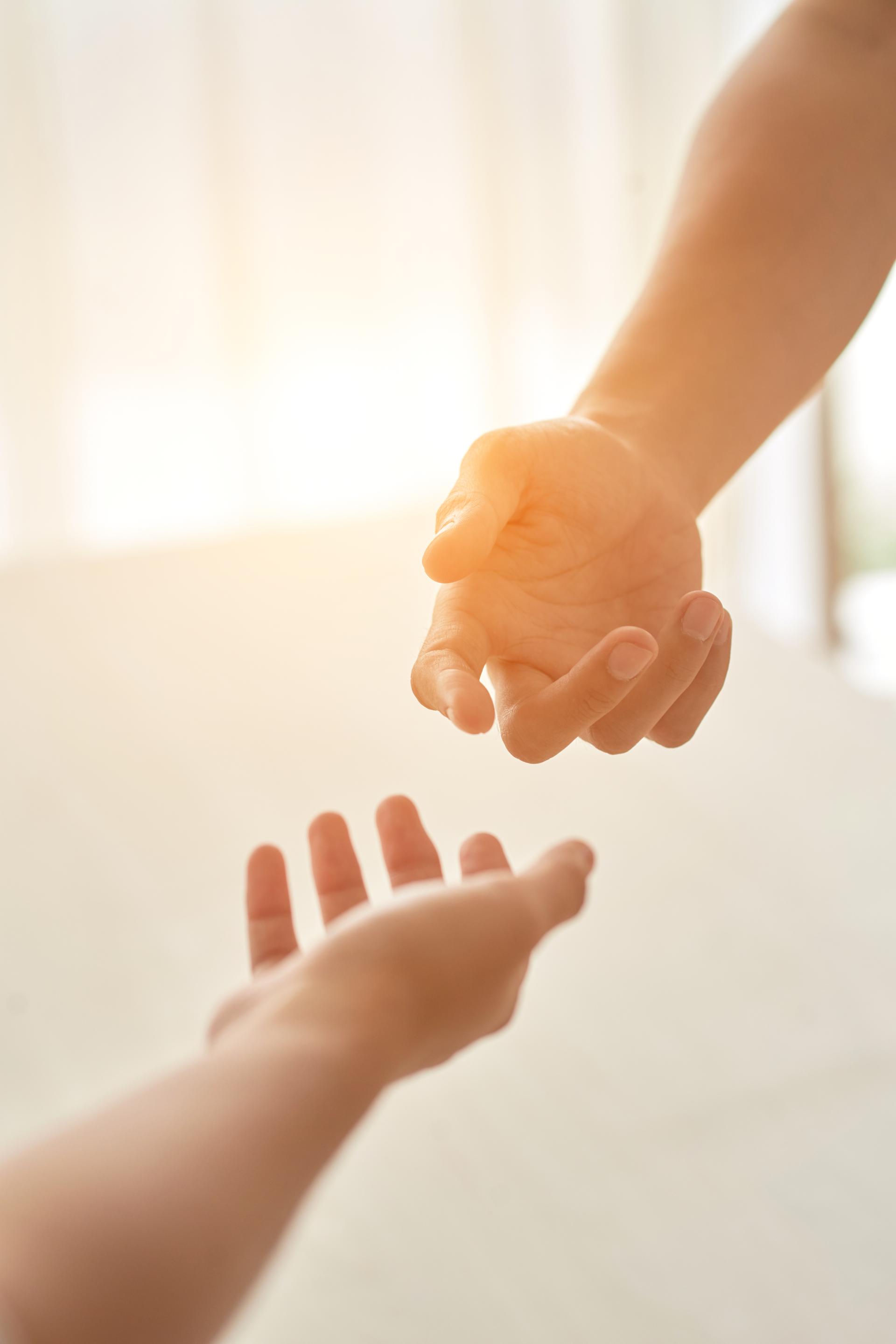 Hands Couple Extended Each Other Against Sunlit Room